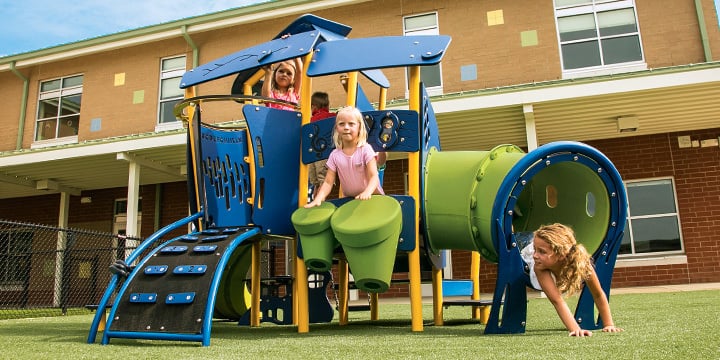 Children playing on a SmartPlay play structure. 