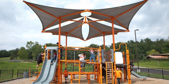 Children playing on a SmartPlay Venti structure with SkyWays shade sails. 