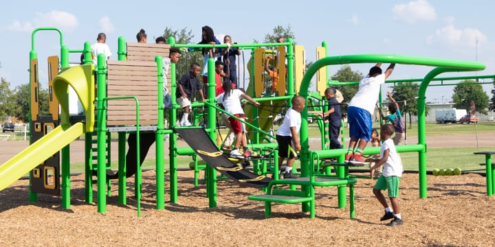 Children playing on bright green SmartPlay Venti play structure. 