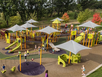 Overhead view of an inclusive playground with many inclusive playground equipment structures
