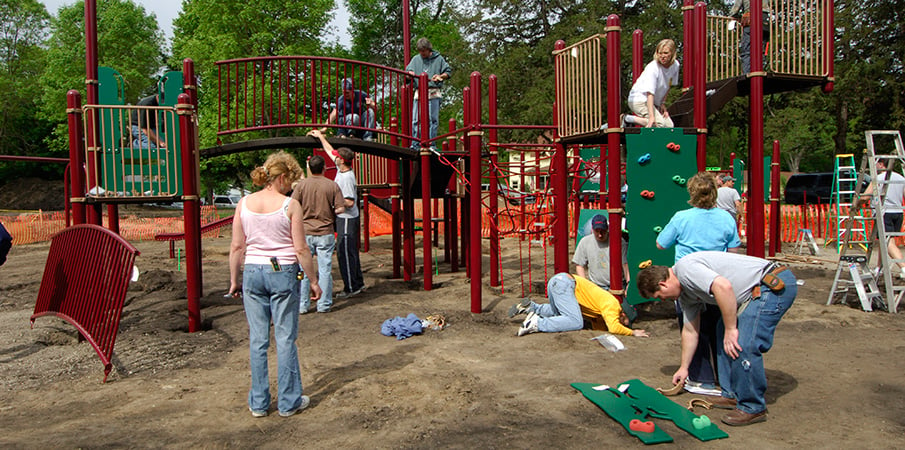 Volunteers building a PlayBooster playground.