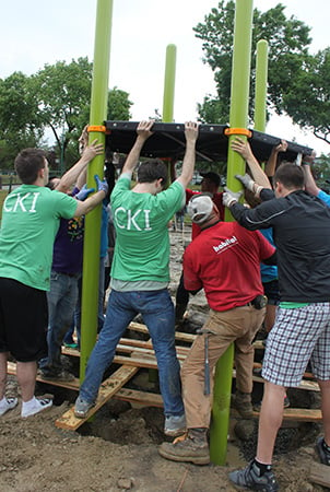 Volunteers building a playground decking system.