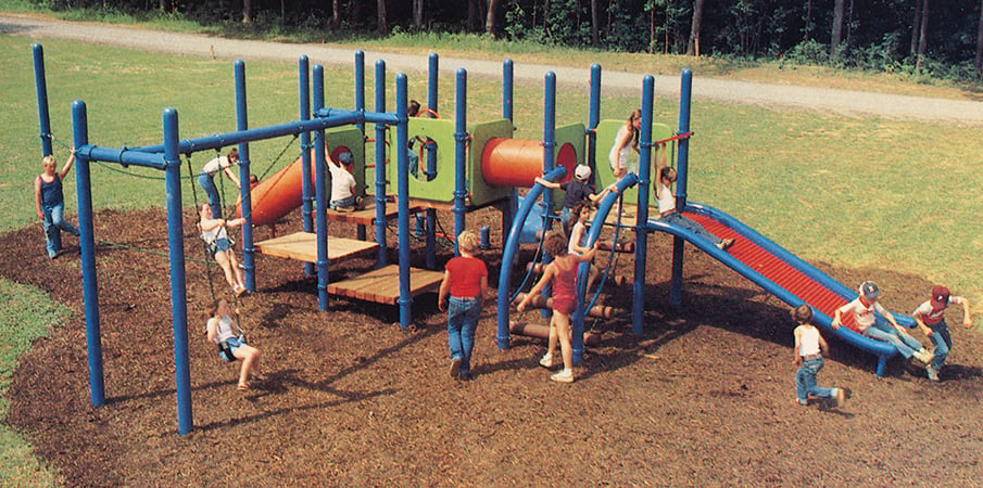 Children playing on an early Landscape Structures playground.