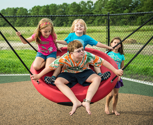 The Oodle® Swing encourages healthy interaction among children of all abilities.
