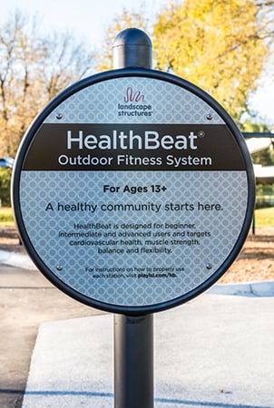 Sign reading "HealthBeat Outdoor Fitness System" 
