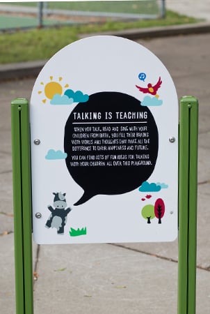 A sign reading "Talking is Teaching" 
