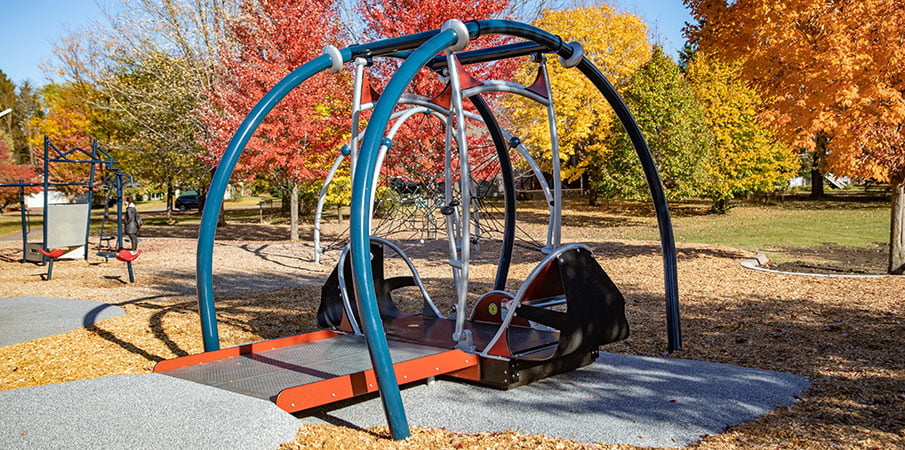 The We-Go-Swing is a wheelchair-friendly swingset that is part of an inclusive playground. It includes a wheelchair ramp for easy accessibility.