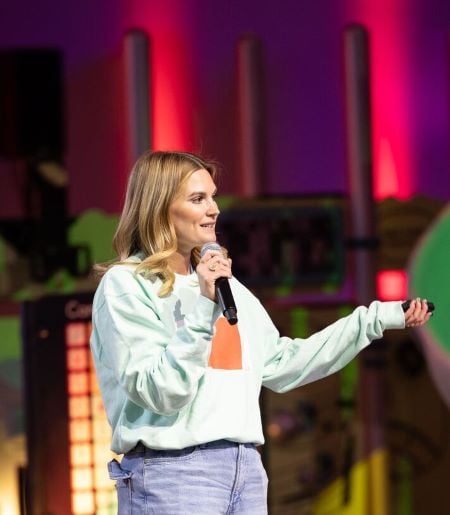 Ariel Mansholt speaking on stage during the annual sales meeting for Landscape Structures