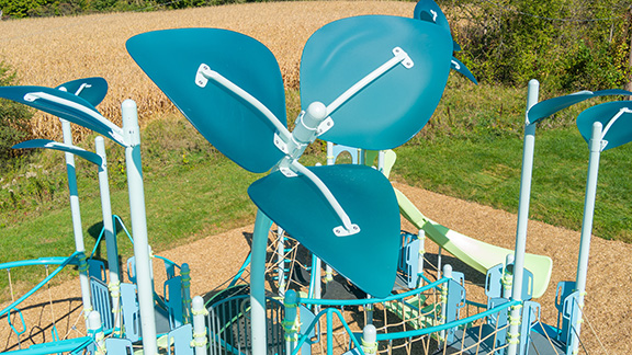 Close up on flower-shaped detail on top of playground post