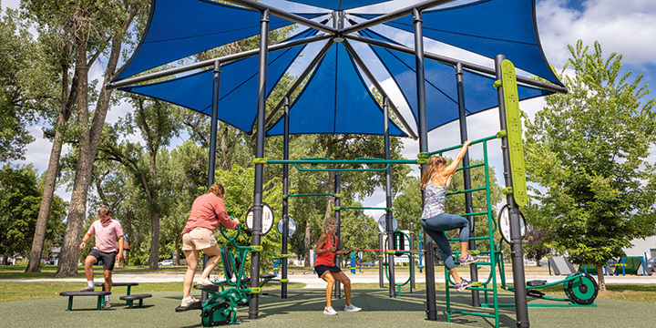 Adults working out on outdoor exercise equipment 