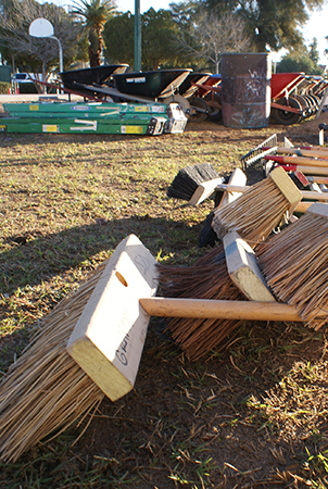 Closeup on brooms at a playground installation site. 