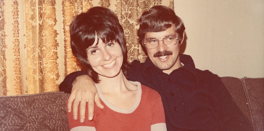 Steve and Barb Landscape Structure founders sitting on couch, vintage photo.
