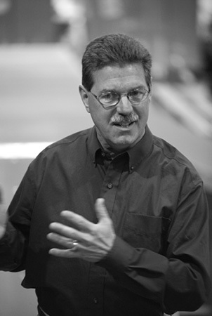 Black and white photo of Steve King in the process of giving a presentation. 