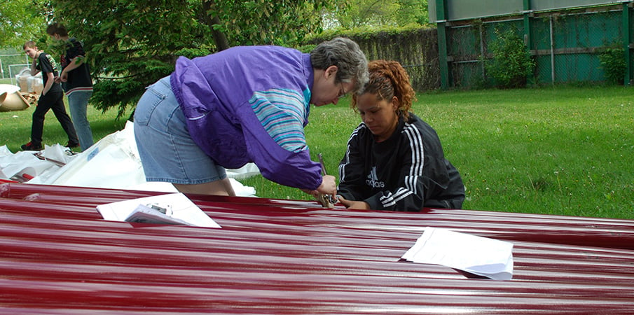 Volunteers assembling playground equipment.