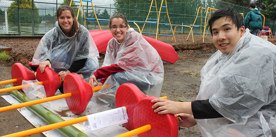 Volunteer playground builders pose for a group photo.