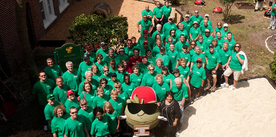 Volunteer playground builders take a  group photo.