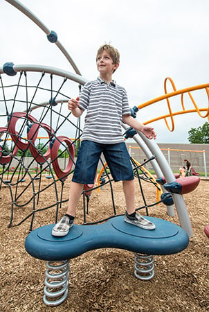 Young boy stands on an Evos Wobble Pod.