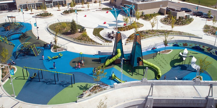 Overhead image of Howard Park playground featuring navy, bright blue and green surfacing, two central climbing towers and multiple freestanding playground elements on the periphery. 